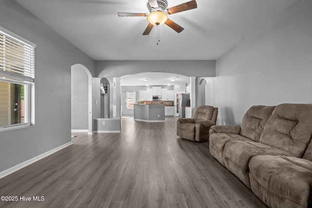 399 Highgrove Dr, Spring Lake, NC 28390 - living room featuring arched walkways, ceiling fan, dark wood-style floors, and baseboards
