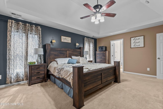 399 Highgrove Dr, Spring Lake, NC 28390 - bedroom featuring a raised ceiling, light colored carpet, baseboards, and a ceiling fan