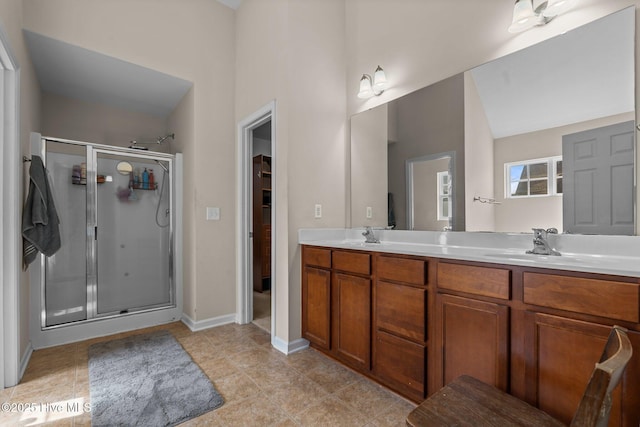 399 Highgrove Dr, Spring Lake, NC 28390 - bathroom featuring a stall shower, double vanity, tile patterned flooring, and baseboards