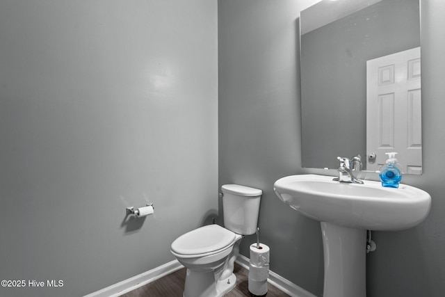 399 Highgrove Dr, Spring Lake, NC 28390 - half bath featuring toilet, wood finished floors, and baseboards