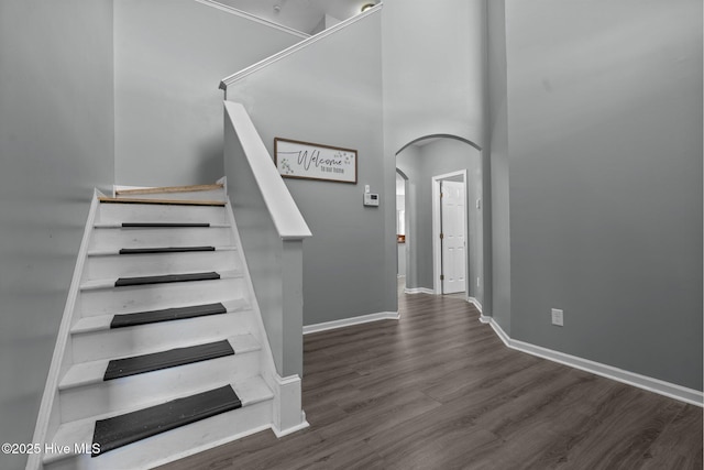 399 Highgrove Dr, Spring Lake, NC 28390 - staircase with arched walkways, wood finished floors, and baseboards