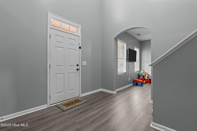 399 Highgrove Dr, Spring Lake, NC 28390 - entryway with arched walkways, wood finished floors, and baseboards