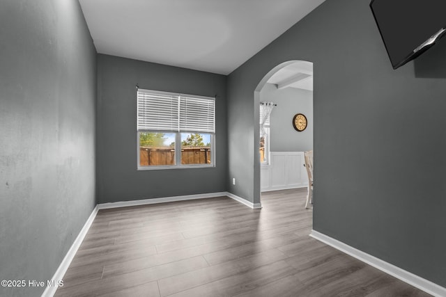 399 Highgrove Dr, Spring Lake, NC 28390 - spare room featuring arched walkways and wood finished floors