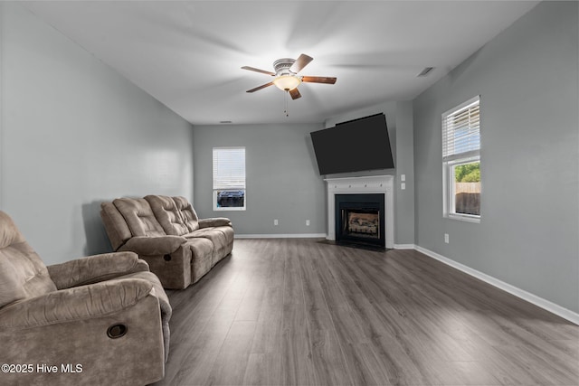 399 Highgrove Dr, Spring Lake, NC 28390 - living room featuring ceiling fan, wood finished floors, healthy amount of natural light, and a fireplace with flush hearth