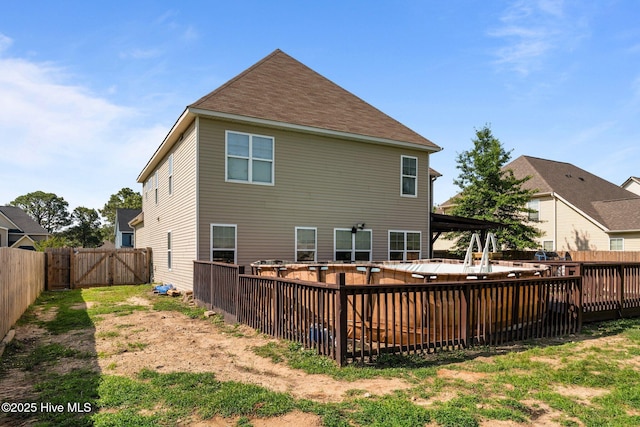 399 Highgrove Dr, Spring Lake, NC 28390 - rear view of house with a fenced backyard, a gate, and a patio area