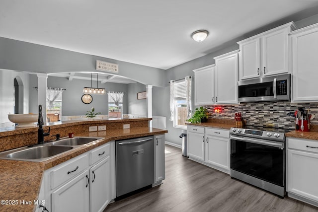 399 Highgrove Dr, Spring Lake, NC 28390 - kitchen featuring stainless steel appliances, a sink, decorative columns, and arched walkways