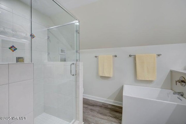 640 Avila Dr, Hampstead, NC 28443 - full bathroom featuring a shower stall, a freestanding tub, wood finished floors, and baseboards