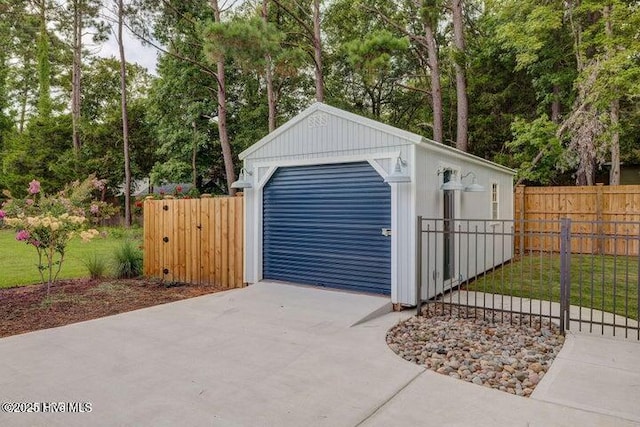 640 Avila Dr, Hampstead, NC 28443 - detached garage with concrete driveway and view of scattered trees