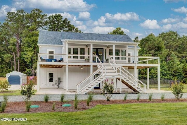 640 Avila Dr, Hampstead, NC 28443 - back of house with a ceiling fan, stairs, board and batten siding, roof with shingles, and a patio