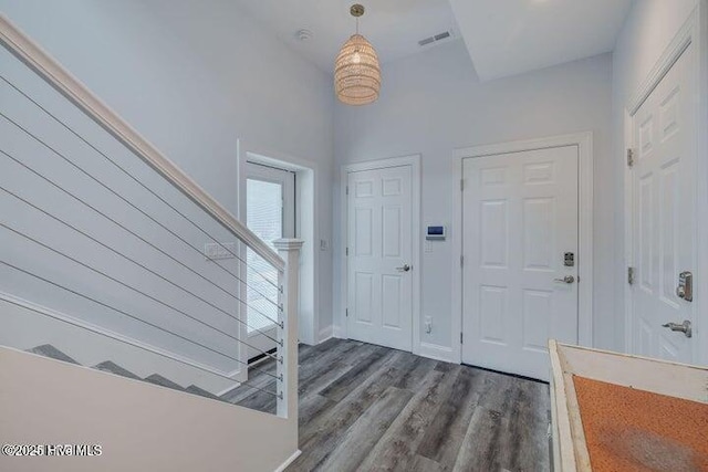 640 Avila Dr, Hampstead, NC 28443 - entrance foyer with dark wood-style flooring, baseboards, and stairs