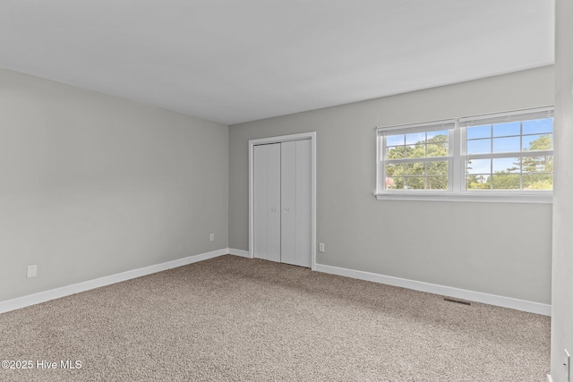 1703 41st St Apt B, Wilmington, NC 28403 - unfurnished bedroom with carpet floors and a closet