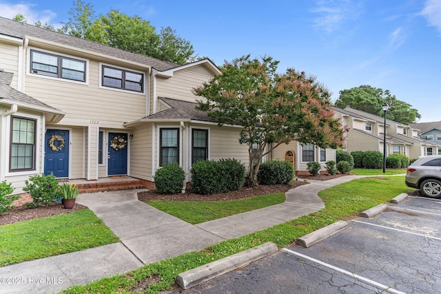 1703 41st St Apt B, Wilmington, NC 28403 - townhome / multi-family property featuring uncovered parking, a front lawn, and a shingled roof