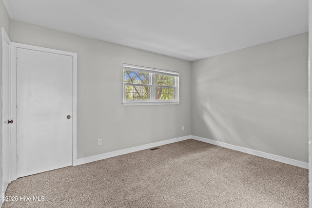 1703 41st St Apt B, Wilmington, NC 28403 - spare room featuring baseboards and carpet floors