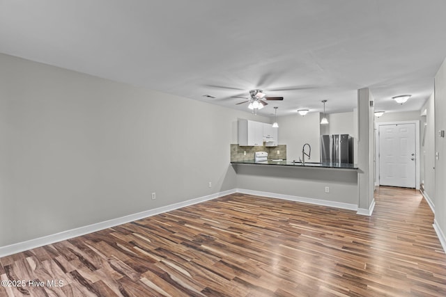 1703 41st St Apt B, Wilmington, NC 28403 - unfurnished living room with dark wood finished floors and ceiling fan