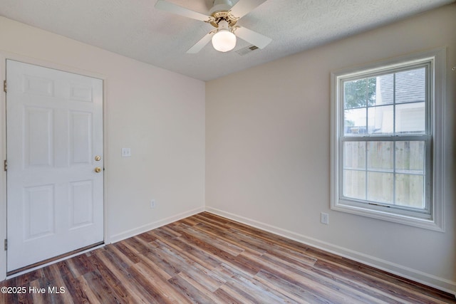 6901 Southern Exposure, Wilmington, NC 28412 - unfurnished room with wood finished floors, baseboards, ceiling fan, and a textured ceiling