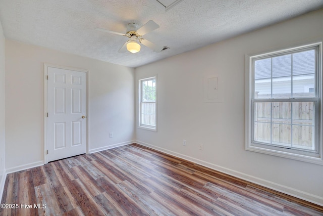 6901 Southern Exposure, Wilmington, NC 28412 - spare room featuring wood finished floors, baseboards, a textured ceiling, and ceiling fan