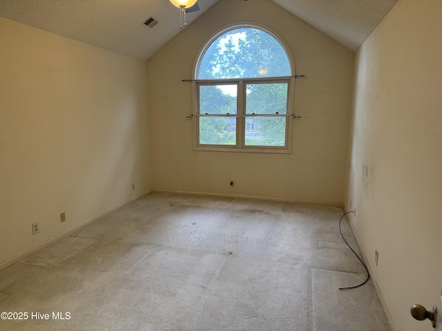 244 Clubhouse Rd Unit 3A, Sunset Beach, NC 28468 - spare room featuring carpet flooring and vaulted ceiling