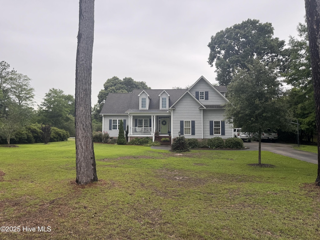 101 Ebb Dr, Wilmington, NC 28411 - cape cod home with a front yard, a porch, and driveway