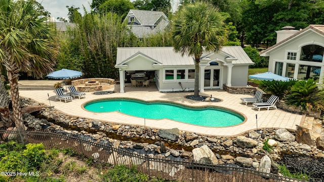 3530 Van Buren St SW, Supply, NC 28462 - view of swimming pool featuring a storage structure, a patio area, a fire pit, and an outdoor structure