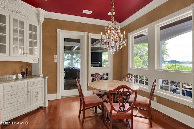 3530 Van Buren St SW, Supply, NC 28462 - dining space with dark wood-style flooring, a chandelier, and crown molding