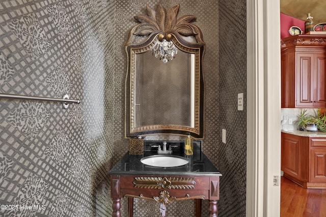 3530 Van Buren St SW, Supply, NC 28462 - bathroom featuring wallpapered walls, wood finished floors, and vanity