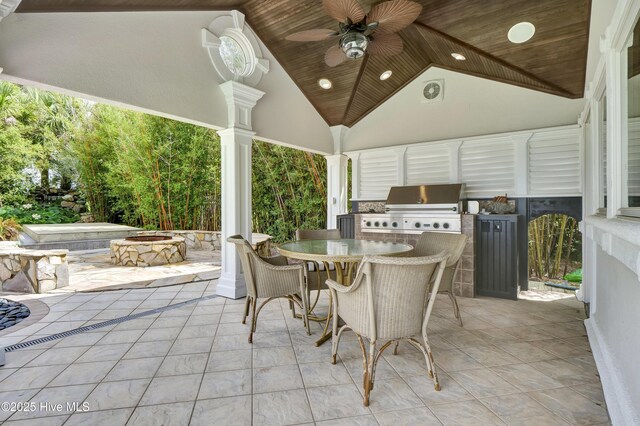 3530 Van Buren St SW, Supply, NC 28462 - view of patio / terrace featuring an outdoor kitchen, outdoor dining area, ceiling fan, and a fire pit