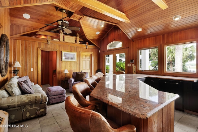 3530 Van Buren St SW, Supply, NC 28462 - kitchen with wooden ceiling, light tile patterned floors, wood walls, a ceiling fan, and open floor plan
