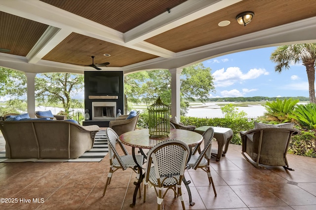 3530 Van Buren St SW, Supply, NC 28462 - view of patio / terrace with a water view, a ceiling fan, an outdoor living space with a fireplace, and outdoor dining area
