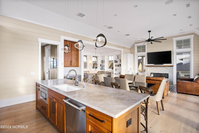 224 W Bald Head Wynd Wynd, Bald Head Island, NC 28461 - kitchen featuring a sink, appliances with stainless steel finishes, brown cabinets, light wood-style floors, and ceiling fan