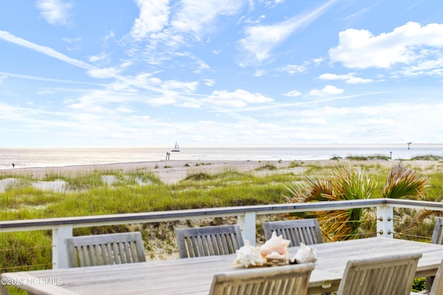 224 W Bald Head Wynd Wynd, Bald Head Island, NC 28461 - deck featuring outdoor dining space and view of water and beach