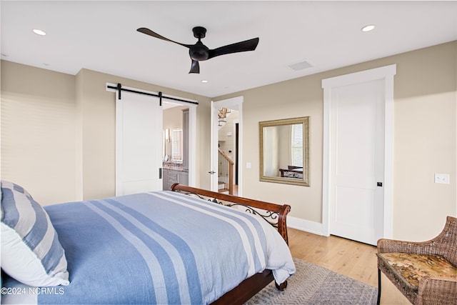 224 W Bald Head Wynd Wynd, Bald Head Island, NC 28461 - bedroom featuring a barn door, light wood-style floors, recessed lighting, baseboards, and ceiling fan
