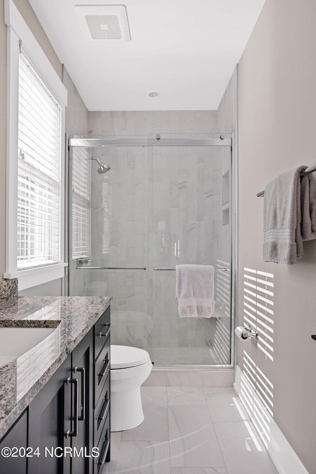 224 W Bald Head Wynd Wynd, Bald Head Island, NC 28461 - bathroom featuring vanity, toilet, a shower stall, and marble look tile flooring