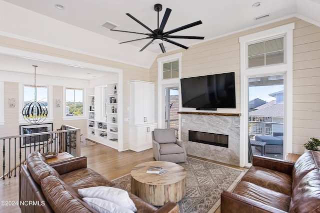 224 W Bald Head Wynd Wynd, Bald Head Island, NC 28461 - living room with vaulted ceiling, ceiling fan, light wood finished floors, wood walls, and a premium fireplace