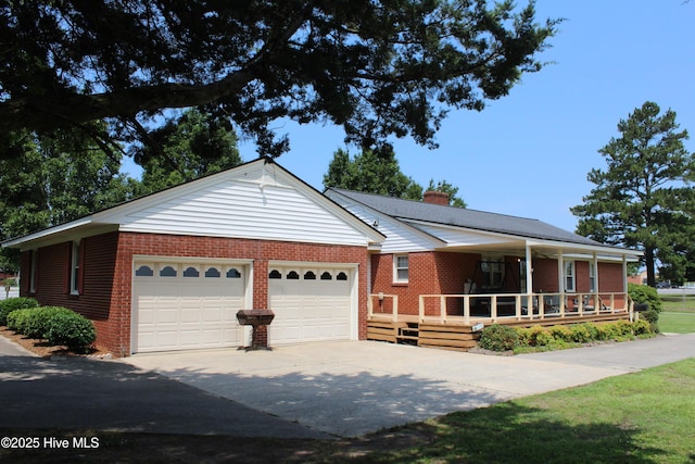 2945 US Highway 17, Williamston, NC 27892 - ranch-style house with brick siding, a garage, driveway, a chimney, and covered porch