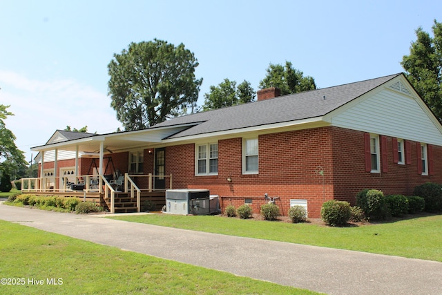 2945 US Highway 17, Williamston, NC 27892 - ranch-style house with brick siding, a porch, a front lawn, and a chimney