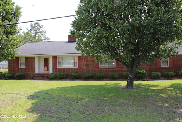 2945 US Highway 17, Williamston, NC 27892 - view of front facade with a front yard, brick siding, and a chimney