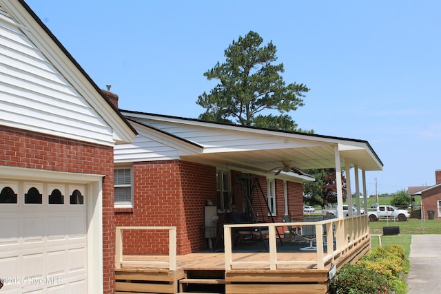 2945 US Highway 17, Williamston, NC 27892 - view of side of property with brick siding, a ceiling fan, a chimney, and an attached garage