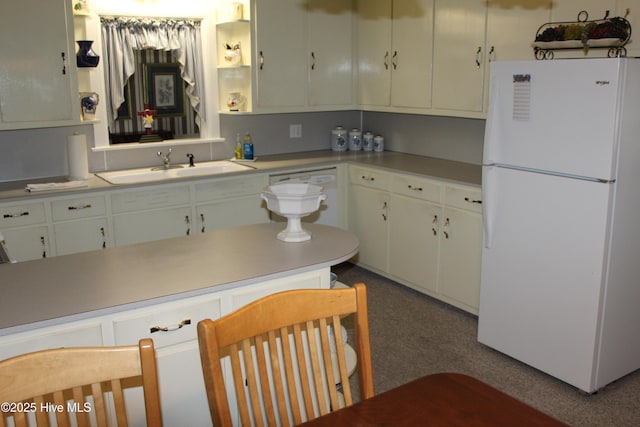 2945 US Highway 17, Williamston, NC 27892 - kitchen with freestanding refrigerator, a sink, light countertops, and white cabinets