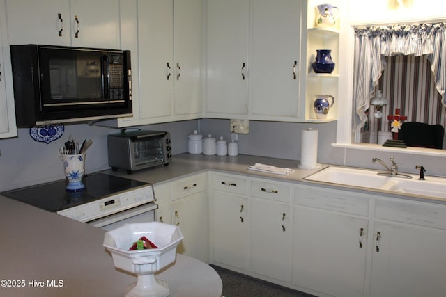 2945 US Highway 17, Williamston, NC 27892 - kitchen with black microwave, a sink, white cabinetry, range, and light countertops