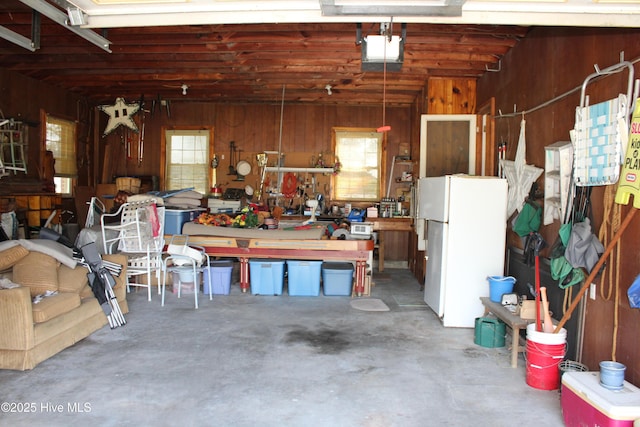 2945 US Highway 17, Williamston, NC 27892 - garage with freestanding refrigerator, wooden walls, a garage door opener, and a workshop area