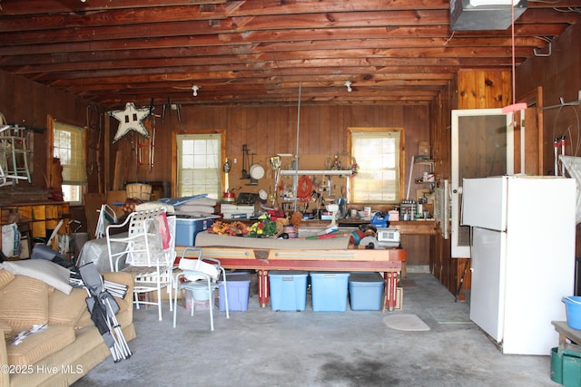 2945 US Highway 17, Williamston, NC 27892 - garage with freestanding refrigerator, wood walls, and a workshop area