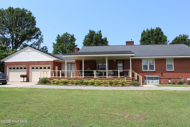 2945 US Highway 17, Williamston, NC 27892 - single story home featuring brick siding, a front yard, driveway, a chimney, and a garage