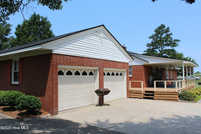 2945 US Highway 17, Williamston, NC 27892 - view of property exterior featuring brick siding, an attached garage, driveway, and covered porch