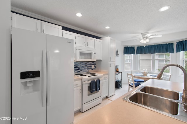 3030 Marsh Winds Cir Unit 605, Southport, NC 28461 - kitchen with white appliances, a sink, white cabinets, a textured ceiling, and light countertops