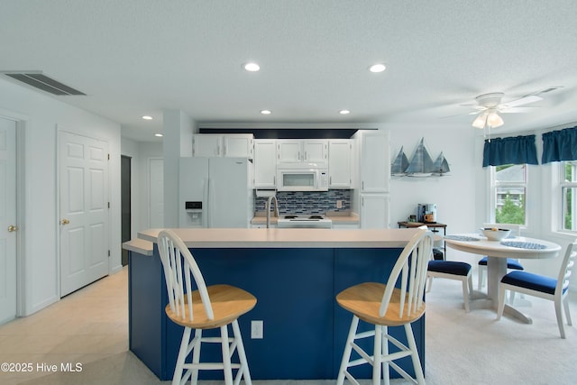 3030 Marsh Winds Cir Unit 605, Southport, NC 28461 - kitchen featuring white appliances, recessed lighting, white cabinetry, decorative backsplash, and light countertops