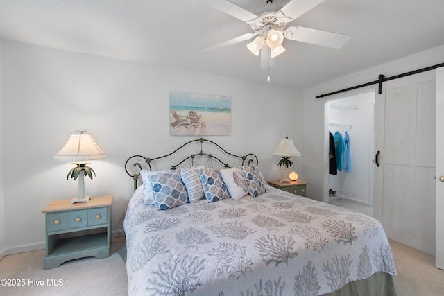 3030 Marsh Winds Cir Unit 605, Southport, NC 28461 - bedroom featuring light carpet, a barn door, a spacious closet, a closet, and baseboards