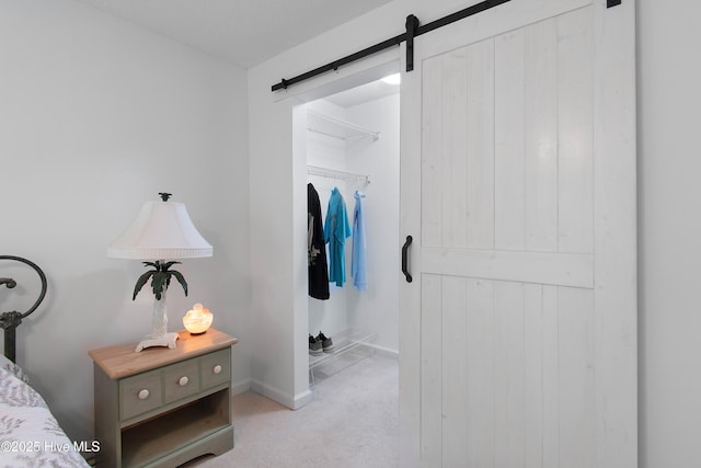 3030 Marsh Winds Cir Unit 605, Southport, NC 28461 - carpeted bedroom featuring a barn door and baseboards