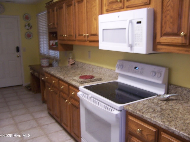 145 Pinehurst Trace Dr, Pinehurst, NC 28374 - kitchen featuring white appliances, brown cabinets, and light stone countertops