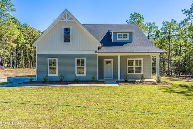 355 Shaw Rd, Cameron, NC 28326 - view of front of house featuring a front lawn, roof with shingles, covered porch, and board and batten siding