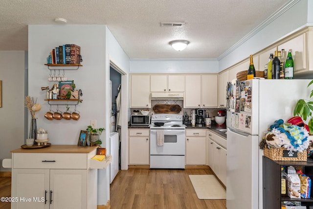 225 Candlewood Dr, Wilmington, NC 28411 - kitchen with white appliances, under cabinet range hood, light wood finished floors, a textured ceiling, and backsplash